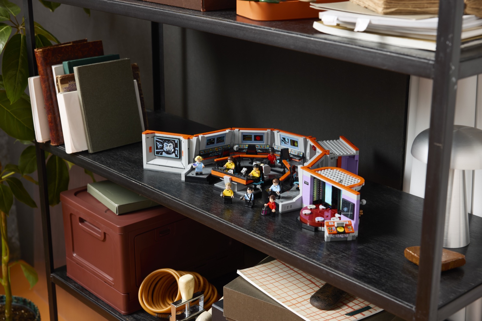 LEGO Star Trek Enterprise bridge and transporter room with its crew displayed on a dark shelf