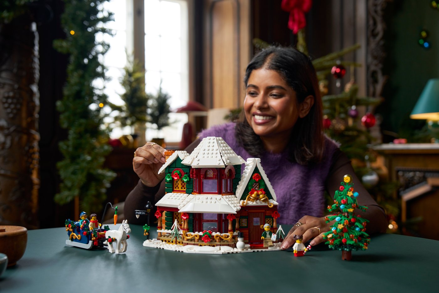 A builder working on LEGO Holiday House 11387