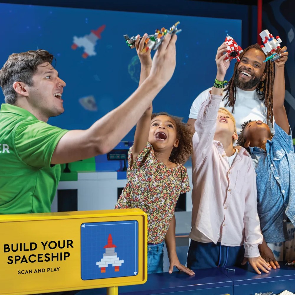 Family building a spaceship at LEGO Discovery Center Atlanta