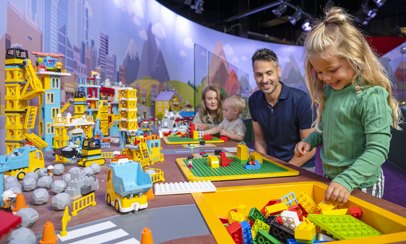 Family exploring Mini World at LEGO Discovery Center Boston